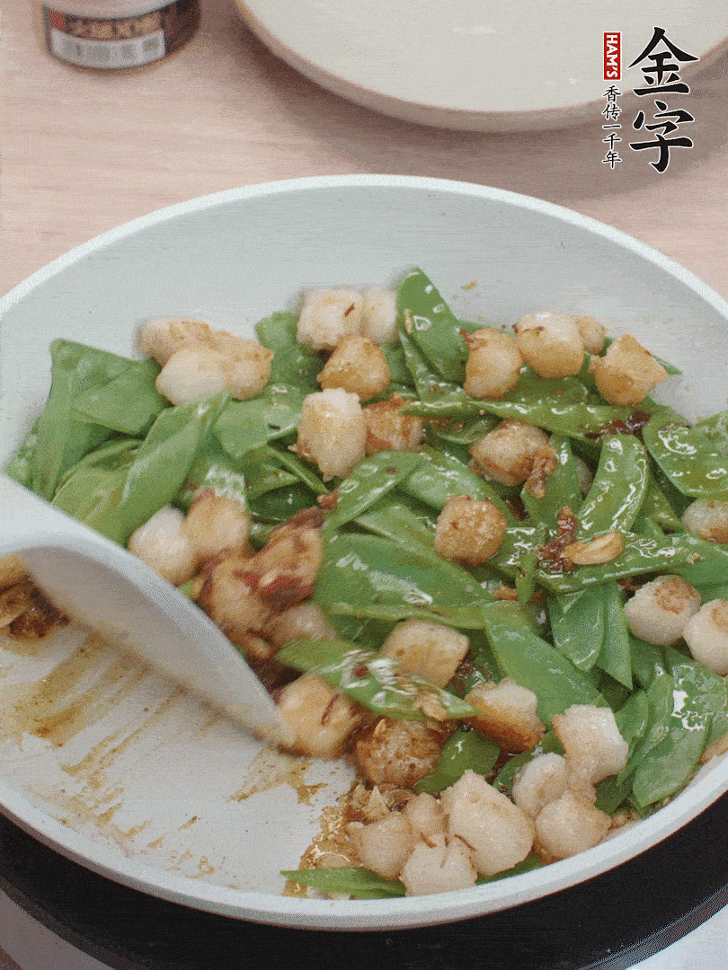下甜豆莢、鮮貝輕輕翻炒均勻。